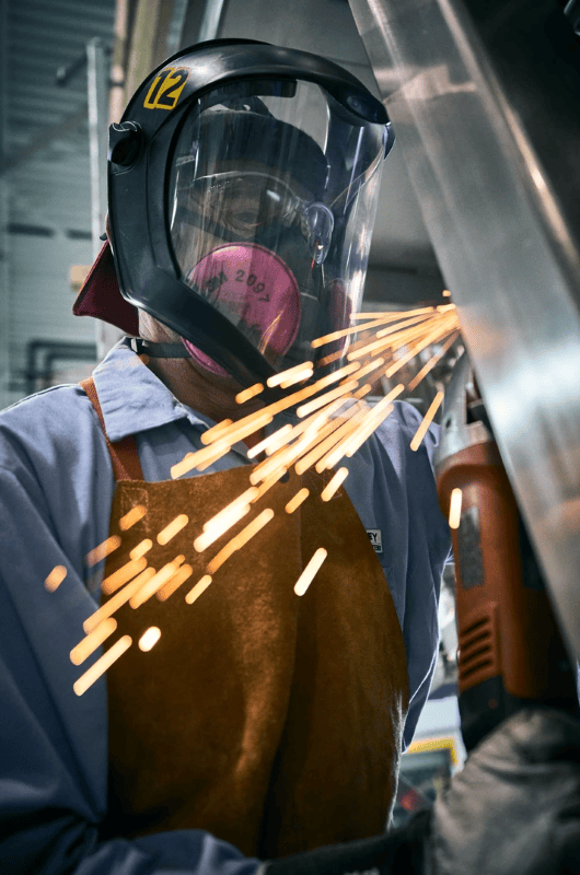 Person grinding metal producing sparks